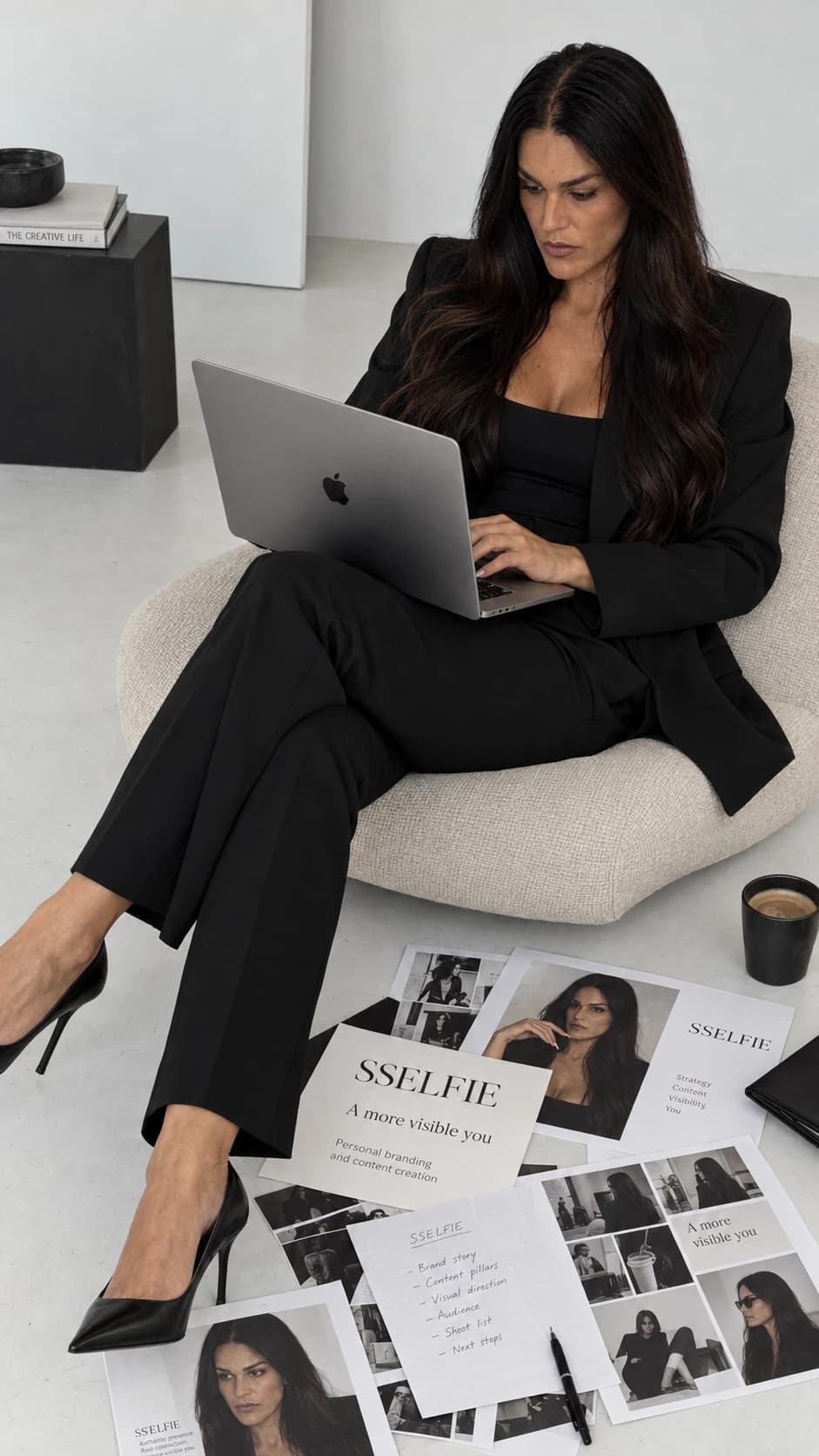 AI image of Sandra working on a laptop with SSELFIE shoot plans around her.